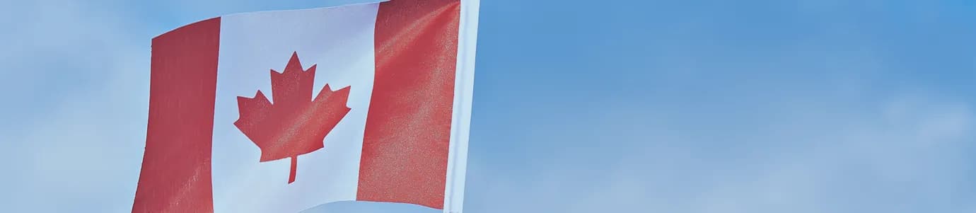 Canadian flag background featuring red and white colors with a centered maple leaf